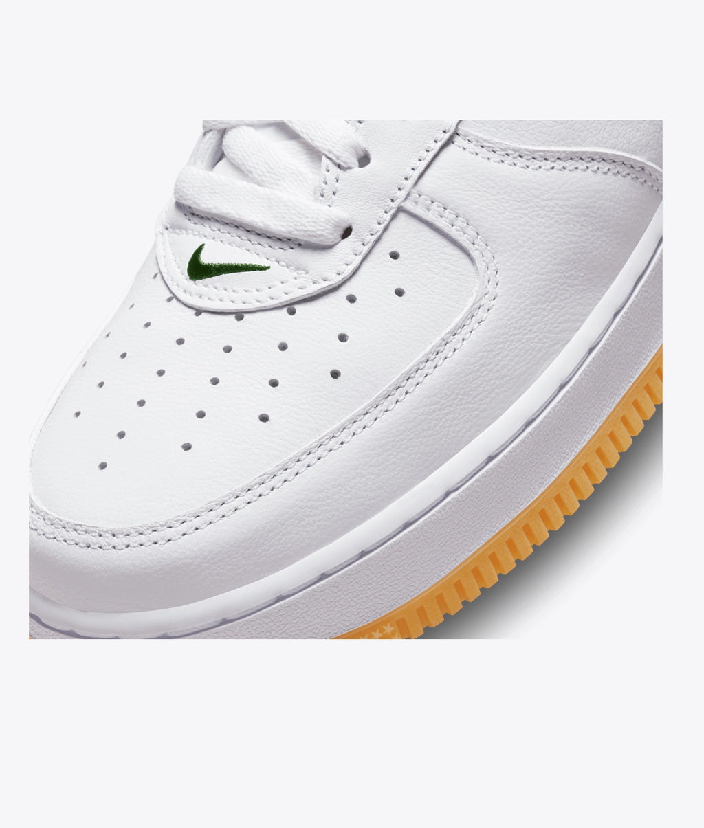 Air Force 1 Low sneakers feature a dark green swoosh